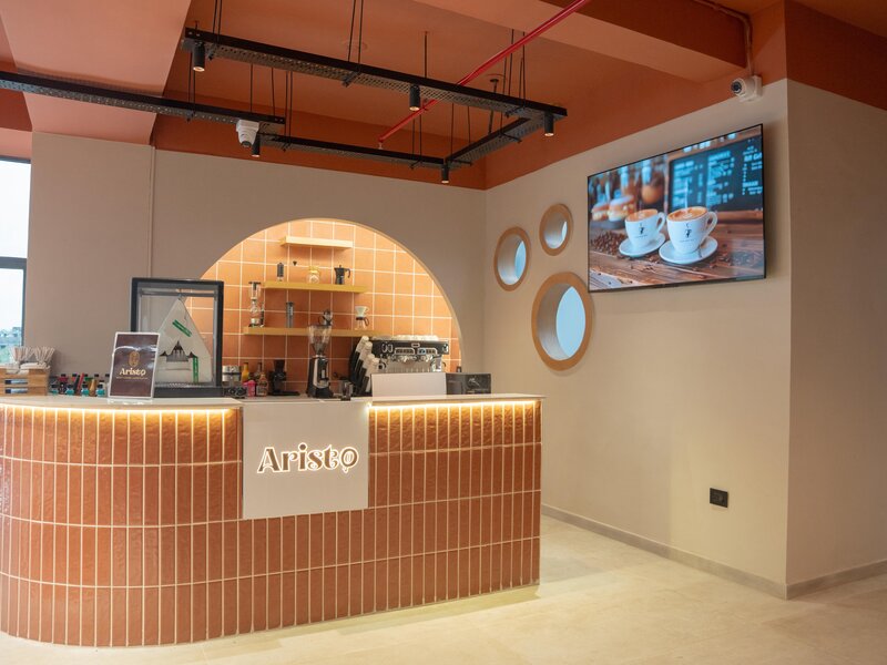 Aristo Cafe interior showing premium modern design and elegant seating arrangements in Bapunagar Ahmedabad